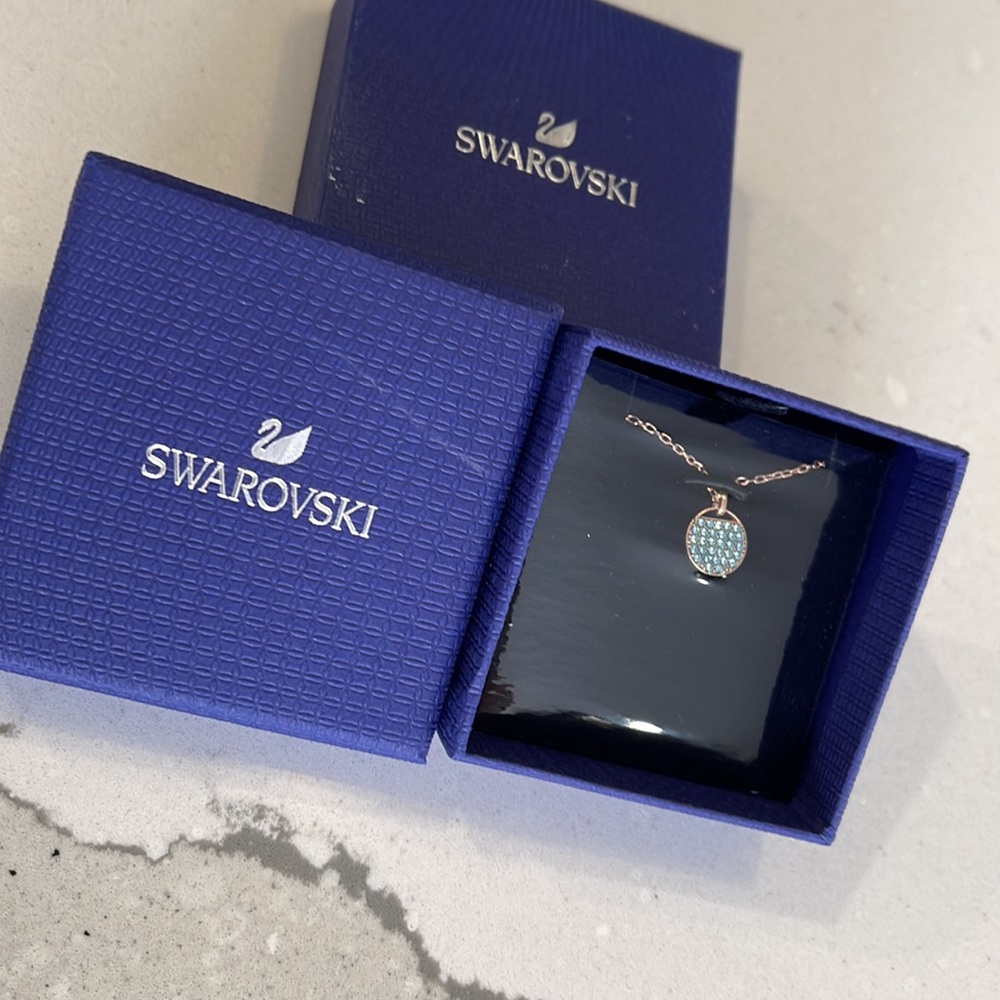 Swarovski aqua/rose gold pendant. New in box never opened/worn.